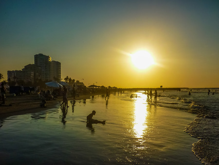 CARTAGENA, COLOMBIA, DECEMBER - 2014 - Sunset scene with crowded beach in Cartagena, the most famous seaside resort of Colombia, South America.のeditorial素材