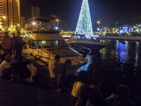 CARTAGENA, COLOMBIA, JANUARY - 2015 - Young people sitting at the shore of urban lake in a summer night in Cartagena, the most famous seaside resort of Colombia.のeditorial素材