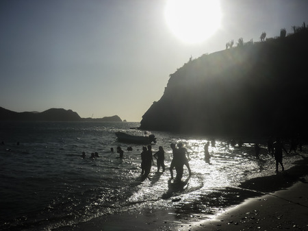 People enjoying a summer day at the beach of the bay of Taganga, a famous caribbean watering place of Colombia, South America.の写真素材
