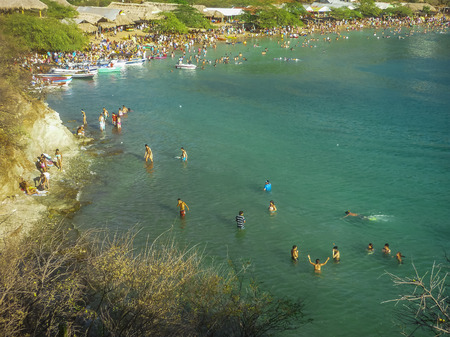 People enjoying a summer day at the beach of the bay of Taganga, a famous caribbean watering place of Colombia, South America.の写真素材
