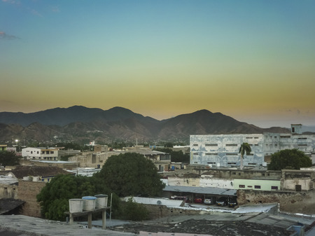 Sunset scene aerial view of buildings and mountains in Santa Marta, one of the most important watering placesof Colombia.のeditorial素材