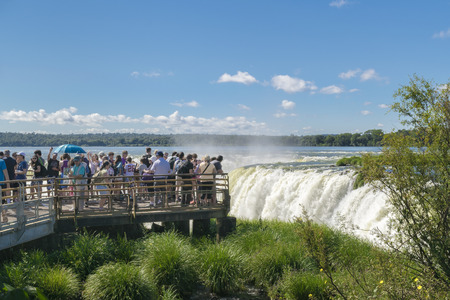PORT IGUAZU, ARGENTINA, MARCH - 2015 - Tourists enjoying a spectacular view of devil throat falls at Iguazu park at argentinian border.のeditorial素材
