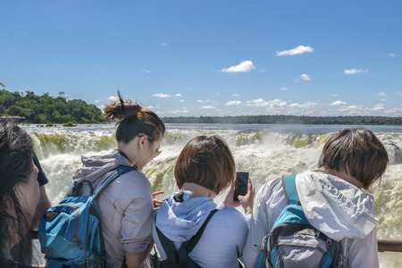 PORT IGUAZU, ARGENTINA, MARCH - 2015 - Tourists taking photos of devil throat falls at Iguazu park at argentinian border.のeditorial素材