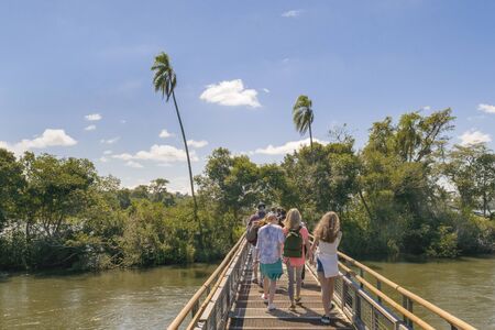 PORT IGUAZU, ARGENTINA, MARCH - 2015 - Tourists crossing the bridge which goes to devil throat falls at Iguazu park at argentinian border.のeditorial素材