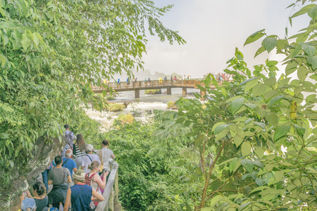 FOZ DO IGUACU, BRAZIL, APRIL - 2015 - People walking to devil throat view at Iguazu national park falls at the brazilian border.のeditorial素材