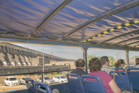 FOZ DO IGUAZU, BRAZIL, APRIL - 2015 - People at a bus trip to Itaipu dam installations at the brazilian borderのeditorial素材