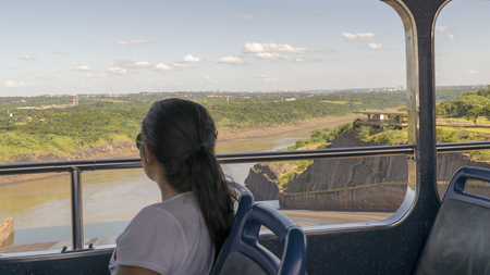 FOZ DO IGUAZU, BRAZIL, APRIL - 2015 - Woman at a bus trip to Itaipu dam installations at the brazilian borderのeditorial素材