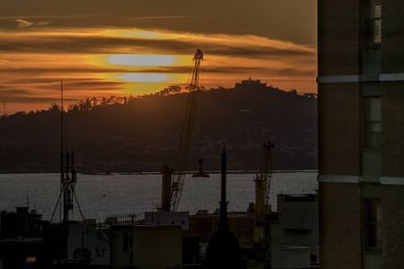 Aerial view at sunset time of bay and the most high hill in the city of Montevideo, the capital of Uruguayの写真素材
