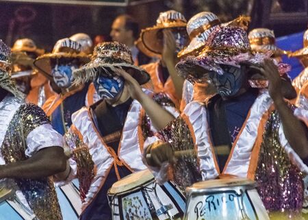 MONTEVIDEO, URUGUAY, JANUARY - 2016 - Costumed men drummers playing traditional music called candombe at the inagural parade of carnival of Montevideo, Uruguayのeditorial素材