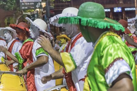 MONTEVIDEO, URUGUAY, JANUARY - 2016 - Costumed men drummers playing traditional music called candombe at the inaugural parade of carnival of Montevideo, Uruguayのeditorial素材