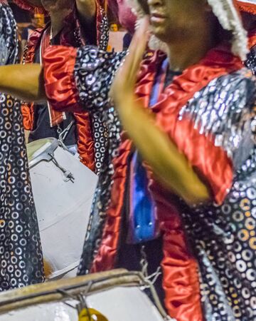 MONTEVIDEO, URUGUAY, JANUARY - 2016 - Costumed men drummers playing traditional music called candombe at the inaugural parade of carnival of Montevideo, Uruguayのeditorial素材