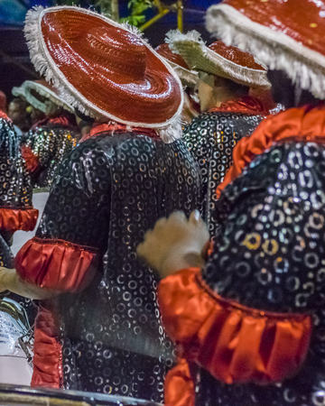 MONTEVIDEO, URUGUAY, JANUARY - 2016 - Costumed men drummers playing traditional music called candombe at the inaugural parade of carnival of Montevideo, Uruguayのeditorial素材