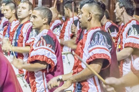 MONTEVIDEO, URUGUAY, JANUARY - 2016 - Costumed men drummers playing traditional music called candombe at the inaugural parade of carnival of Montevideo, Uruguayのeditorial素材