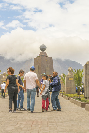 QUITO, ECUADOR, OCTOBER - 2015 - Group of tourists visiting the most visited touristic location in Ecuador, the middle earth monument.のeditorial素材