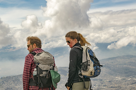 QUITO, ECUADOR, OCTOBER - 2015 - Young couple of hikers watching the view from the rim of mountain in Quito, Ecuador.のeditorial素材