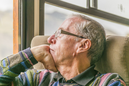 ALAUSI, ECUADOR, OCTOBER - 2015 - Senior man watching through window at interior of touristic train in Alausi, Ecuadorのeditorial素材