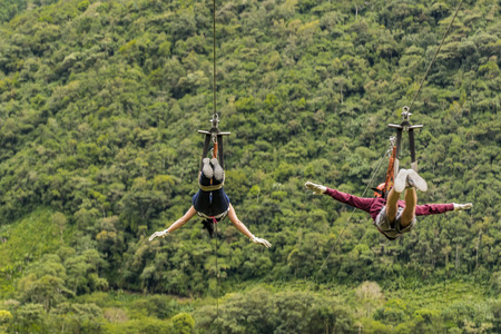 People making canopy, and extreme touristic activity hanged on wire at highs in Banos, Ecuadorの写真素材
