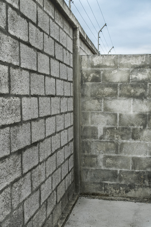 Concrete walls with electricity security cables at top.の写真素材