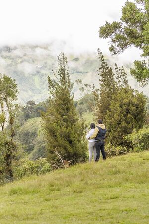 BANOS, ECUADOR, OCTOBER - 2015 - Adult couple hugging at the top of hill in Banos, Ecuadorのeditorial素材