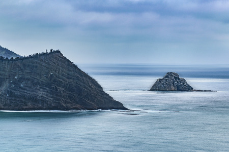 Aerial view of big rocky boulders at coast of pacific ocean in Puerto Lopez town, Ecuador, South Americaの写真素材