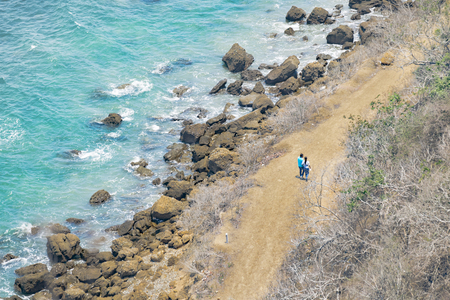 High angle shot of couple walking at road in rocky coastline in Santa Elena, Eucuadorの写真素材