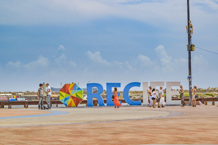 RECIFE, BRAZIL, JANUARY - 2016 - Group of tourist taking photos at Recife letters in Marco Zero squareのeditorial素材