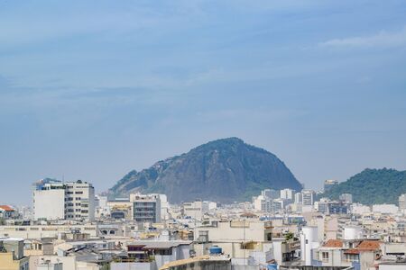 Modern buildings and leafy mountain at background in Rio de Janeiro, Brazil