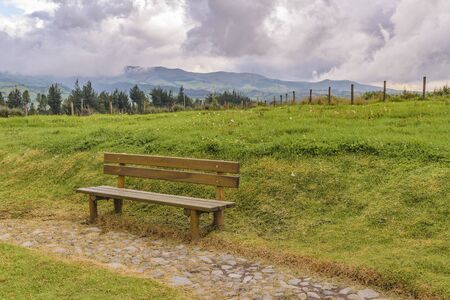 Ecuadorian andean landscape scene with wooden seat as main subjectの写真素材