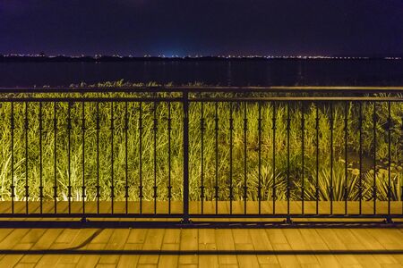 Night scene of guayas river view from riverfront restaurant located in samborondon, a luxurious district of Guayaquil, Ecuadorの写真素材