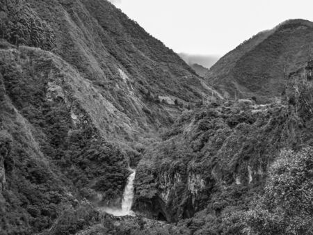 Landscape scene with cascade at the middle of tropical wet forest in Banos, a touristic place located in Ecuador, South America.の写真素材