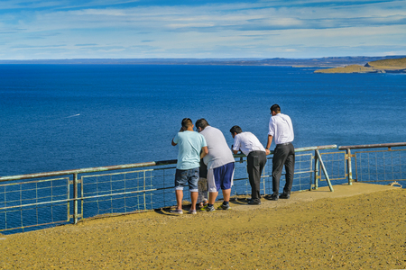 CHUBUT, ARGENTINA, MARCH - 2016 - Group of adult men watching the view at Punta del Marquez, a touristic viewpoint located in Chubut, Argentina.のeditorial素材