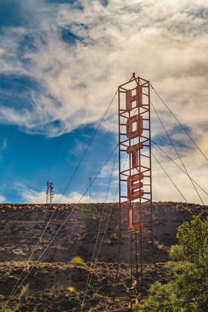 Vertical signpost with hotel word in the middle of nature in Santa Cruz province, Argentina