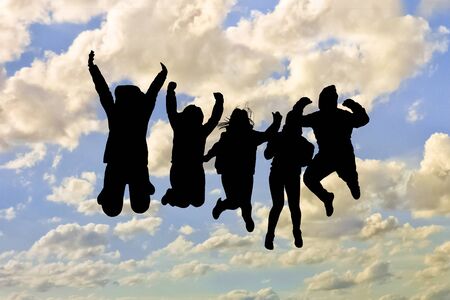 Group of black silhouettes people  jumping against cloudy blue sky backgroundの写真素材