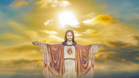 Religious chrisitan background artwork with jesuschrist sculpture against sunset sky backgroundの写真素材