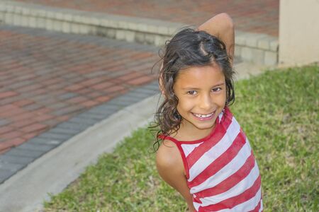 GUAYAQUIL, ECUADOR, AUGUST - 2018 - High angle shot of ecuadorian kid girl smiling at cameraのeditorial素材