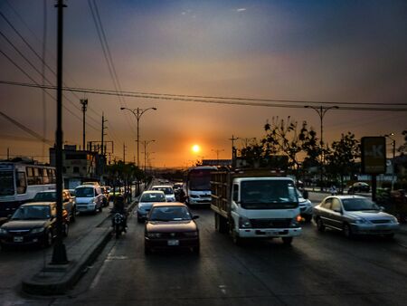 GUAYAQUIL, ECUADOR, NOVEMBER - 2016 - High contrast urban sunset scene at street in Guayaquil, Ecuadorのeditorial素材
