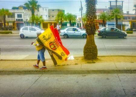GUAYAQUIL, ECUADOR, DECEMBER - 2016 - Street vendor with barcelona soccer team flags at outskirt avenue in Guayaquil, Ecuadorのeditorial素材