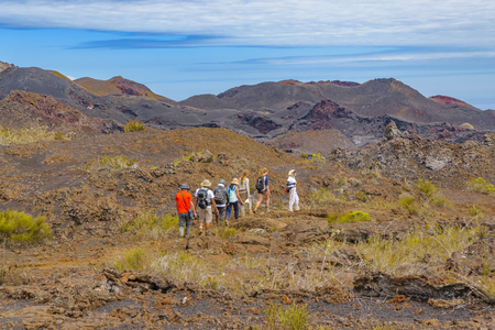 GALAPAGOS, ECUADOR, AUGUST - 2016 - Group of tourist walking at sierra negra trip, a volcanic environment in Isabela island, Galapagos, Ecuadorのeditorial素材