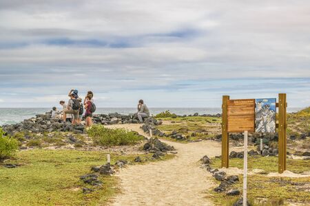 GALAPAGOS, ECUADOR, AUGUST - 2016 - Group of tourist watching the view at coast of beach, Galapagos, Ecuadorのeditorial素材