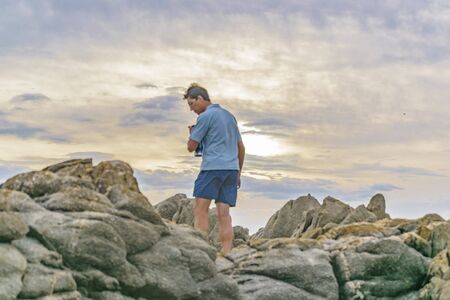MONTEVIDEO, URUGUAY, JANUARY - 2016 - Adult man walking at rocks, Montevideo, Uruguayのeditorial素材