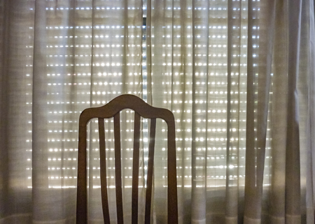 Interior house room scene with window with blinds closed and wooden chairの写真素材