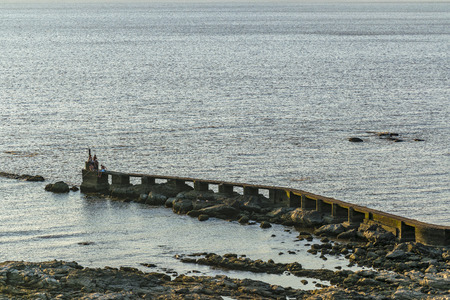 MONTEVIDEO, URUGUAY, JANUARY - 2016 - People fishing at breakwater in the coast of river in Montevideo, Uruguayのeditorial素材