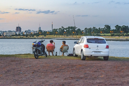 MONTEVIDEO, URUGUAY, JANUARY - 2016 - Cityscape scene with couple at coastal viewpoint in Montevideo city, Uruguayのeditorial素材