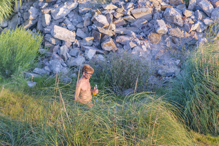 MONTEVIDEO, URUGUAY, JANUARY - 2016 - Shirtless adult man walking at natureのeditorial素材