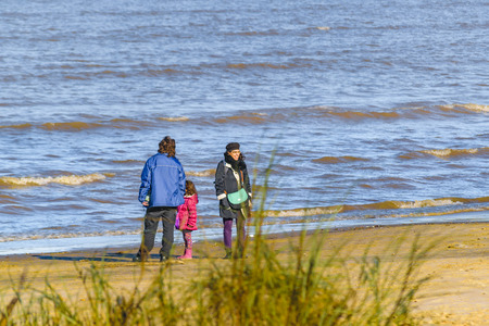 MONTEVIDEO, URUGUAY, JULY - 2016 - Adult couple with children at shore of pocitos beach in Montevideo city, Uruguayのeditorial素材