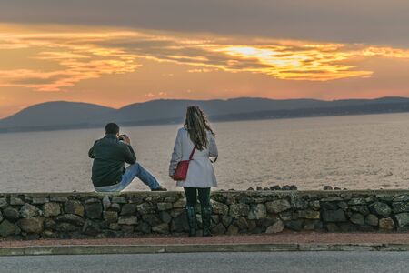PUNTA DEL ESTE, URUGUAY, AUGUST - 2016 - Back view couple taking photos of landscape at Punta del...