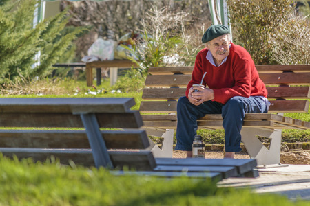 MALDONADO, URUGUAY, AUGUST -  2016 - Senior man sitting at park in Aigua, a small village located in Uruguayのeditorial素材