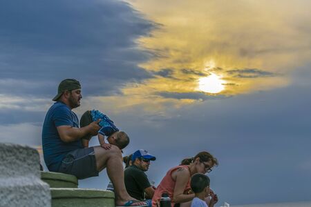 PIRIAPOLIS, URUGUAY, FEBRUARY - 2016 - Family at top of San Antonio hill at sunset time.のeditorial素材