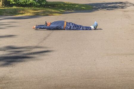 MONTEVIDEO, URUGUAY, MARCH - 2016 - Adult fat man doing exercise at park at botanical garden in...