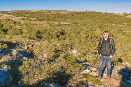 LAVALLEJA, URUGUAY, AUGUST - 2017 - Slim tall adult man watching the view at top of hill at countryside landscapeのeditorial素材